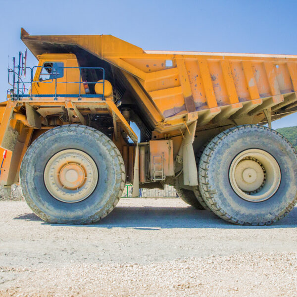 Dump truck in Queensland, highlighting importance of proper training for QLD truck licence applicants, showcasing robust construction and large tires.